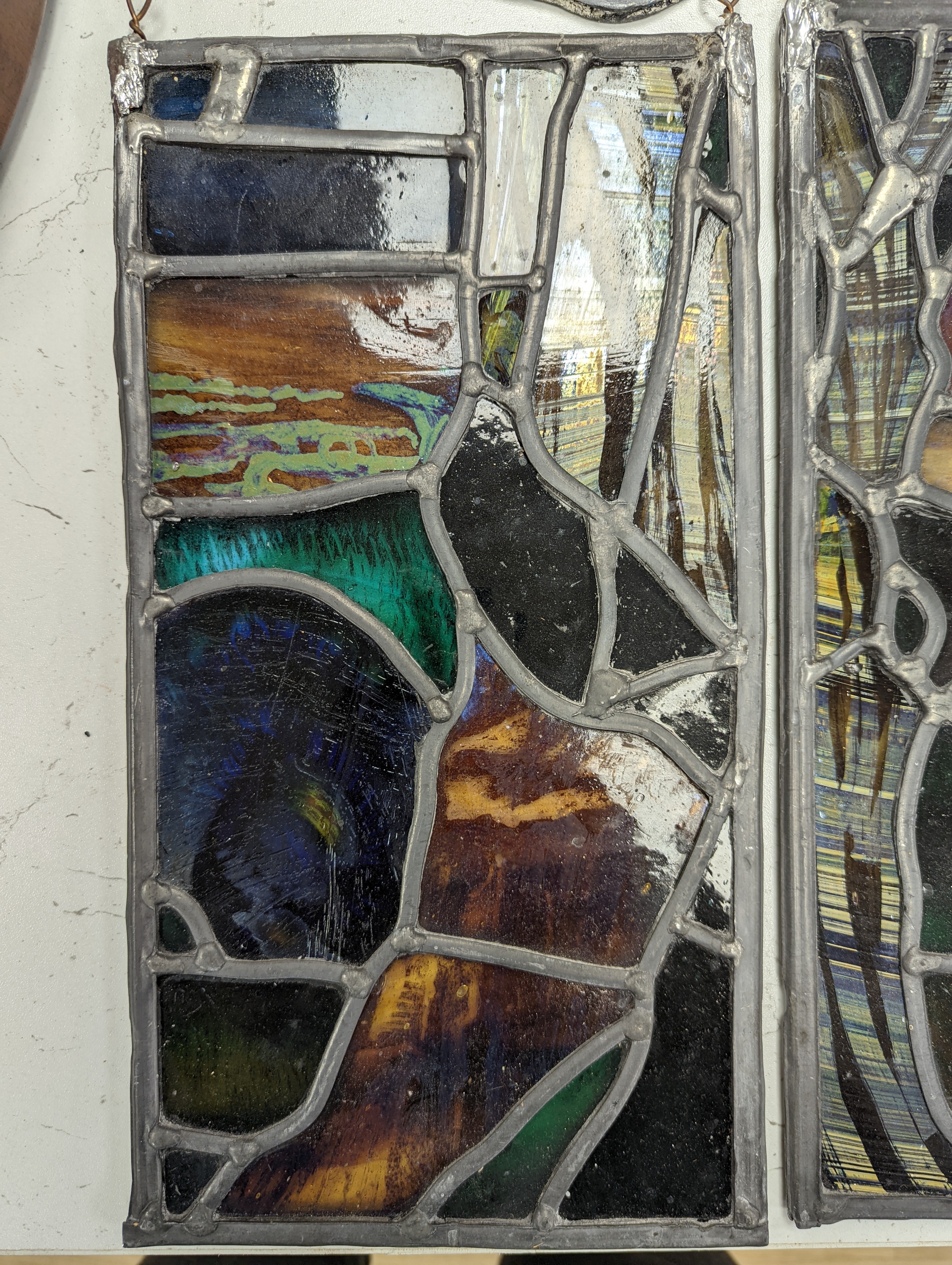 A Victorian stained glass portrait panel, two bird panels and a similar circular bird panel (4)